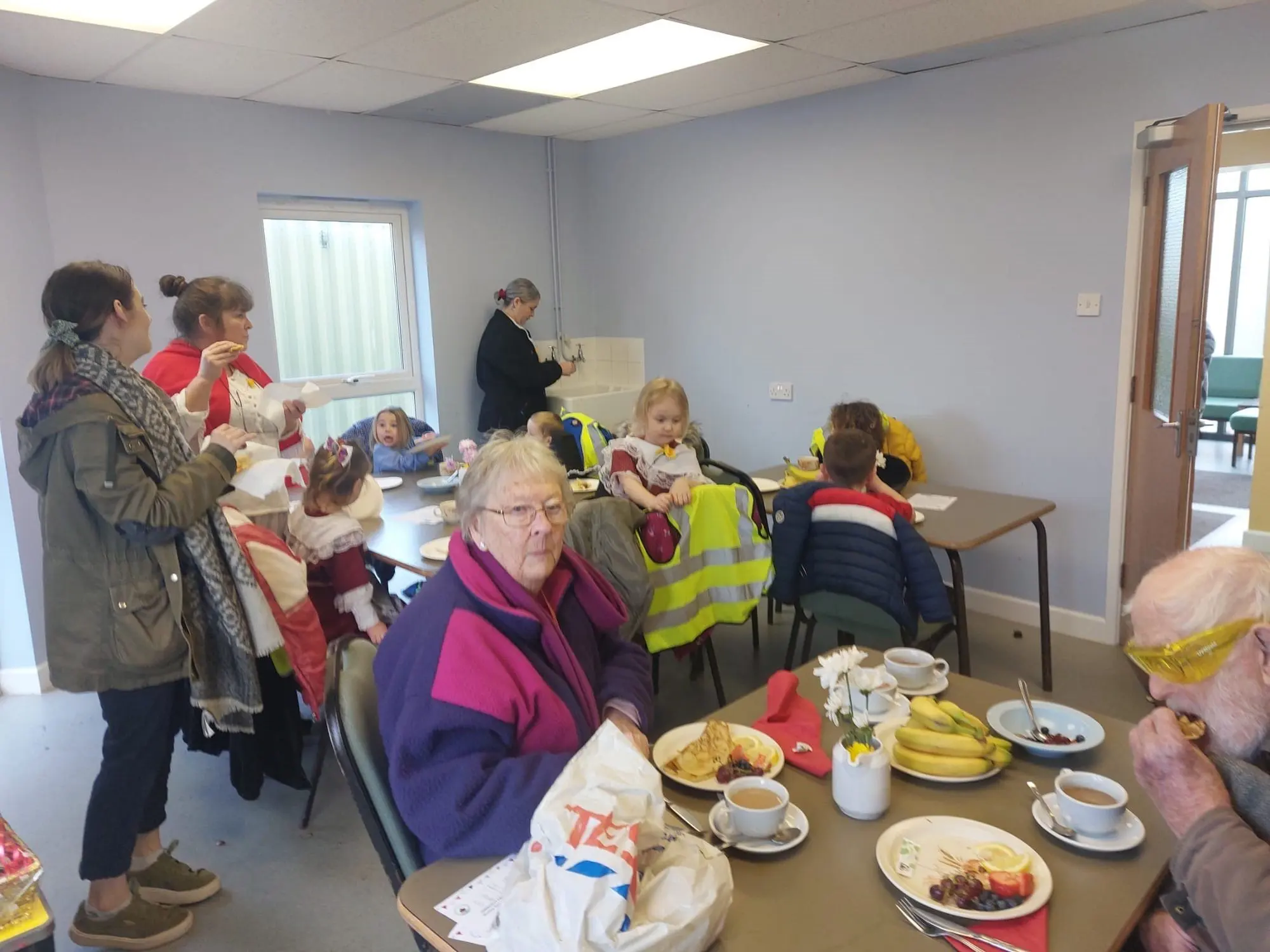 Families enjoying a community lunch