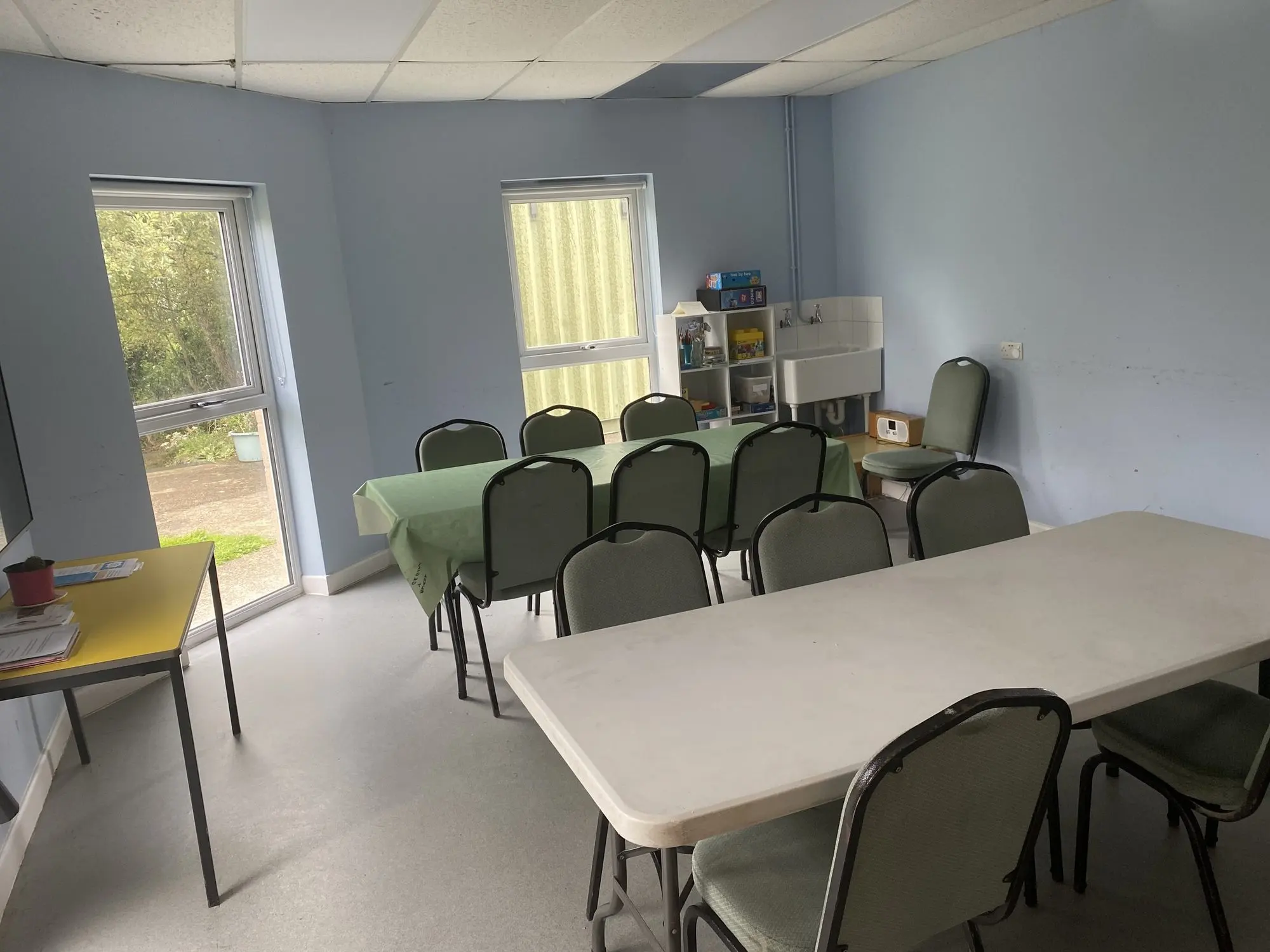 The meeting room at Canolfan Dyffryn set with tables and chairs