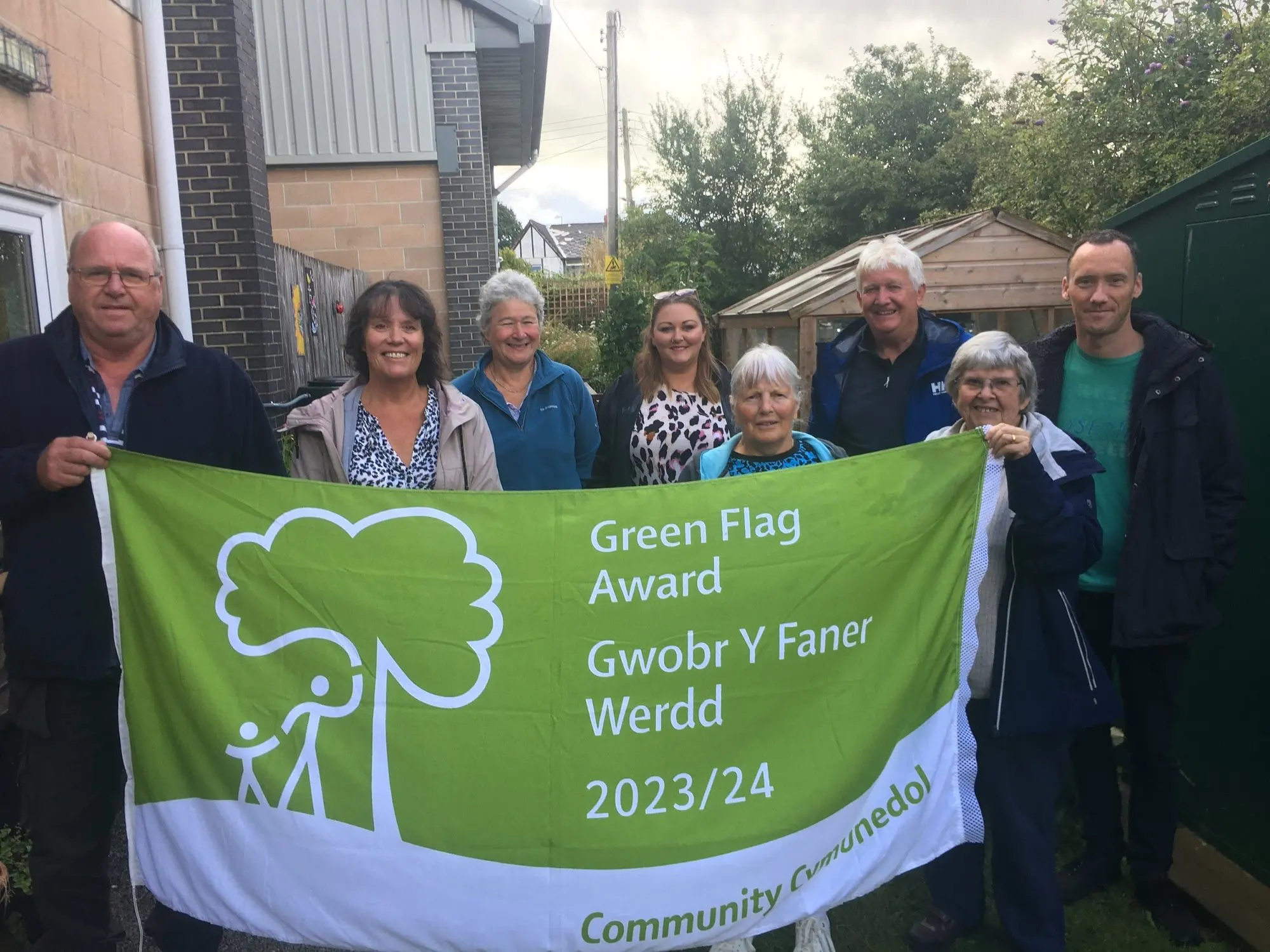 Volunteers holding the Green Flag Community Award