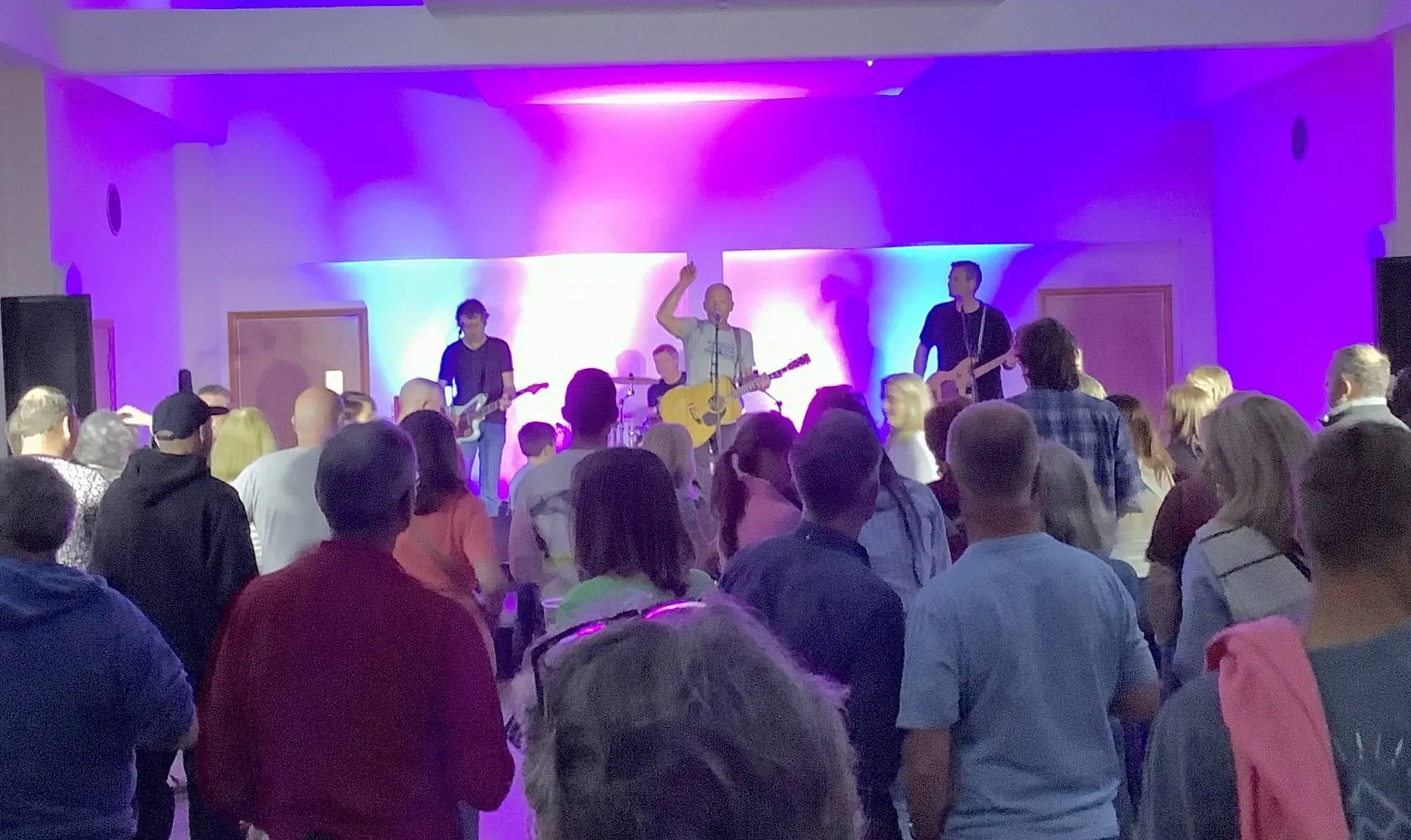 A band playing to a crowd at a live music night